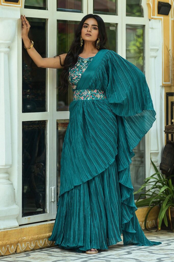 -Elegant green saree with intricate work on blouse, perfect for festive occasions and weddings.
