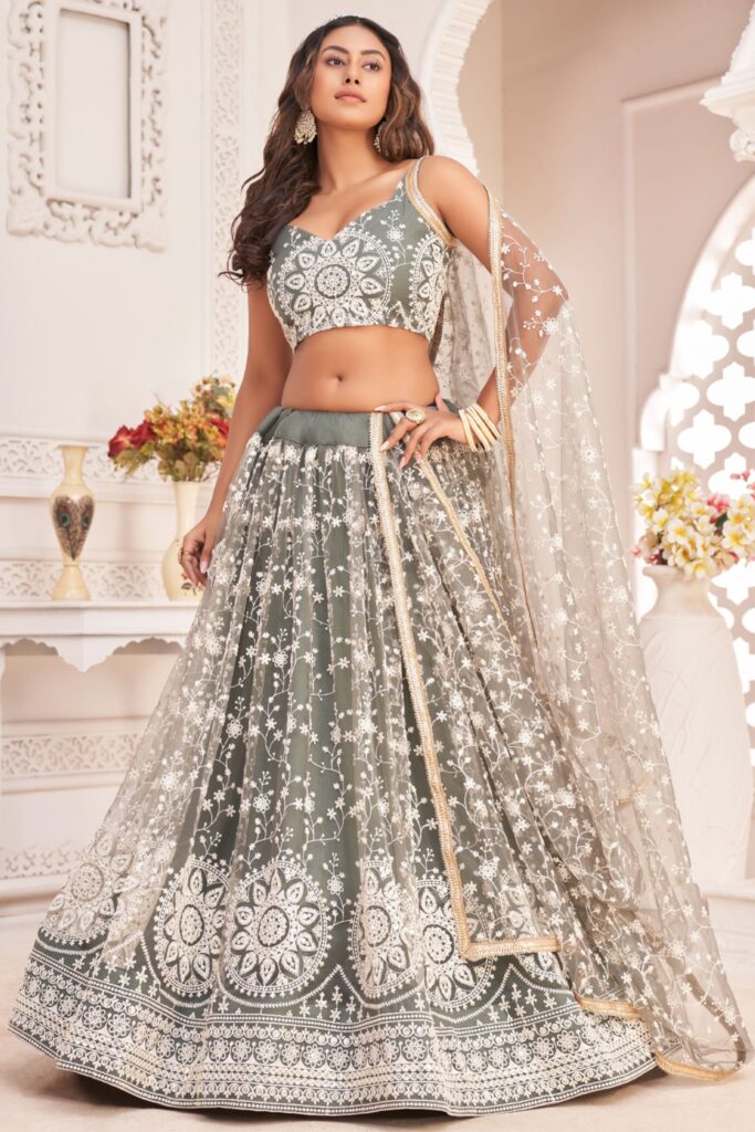 wedding season attire -girl wearing green lehenga with pearl work on it.